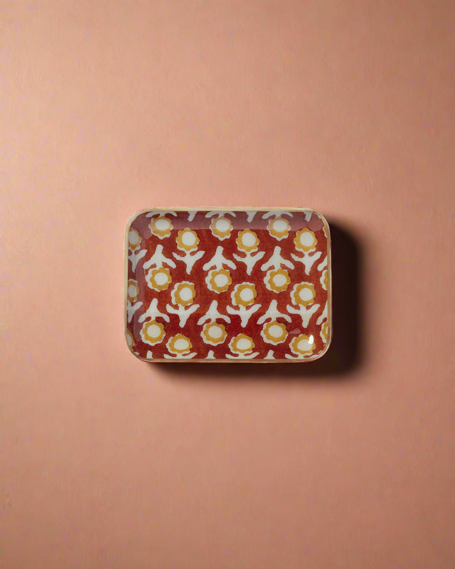 Rectangular ceramic tray with floral pattern on a green background