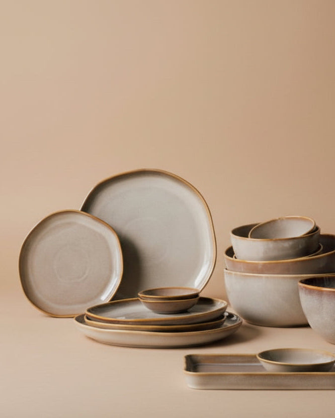 Set of ceramic dishes on a beige background