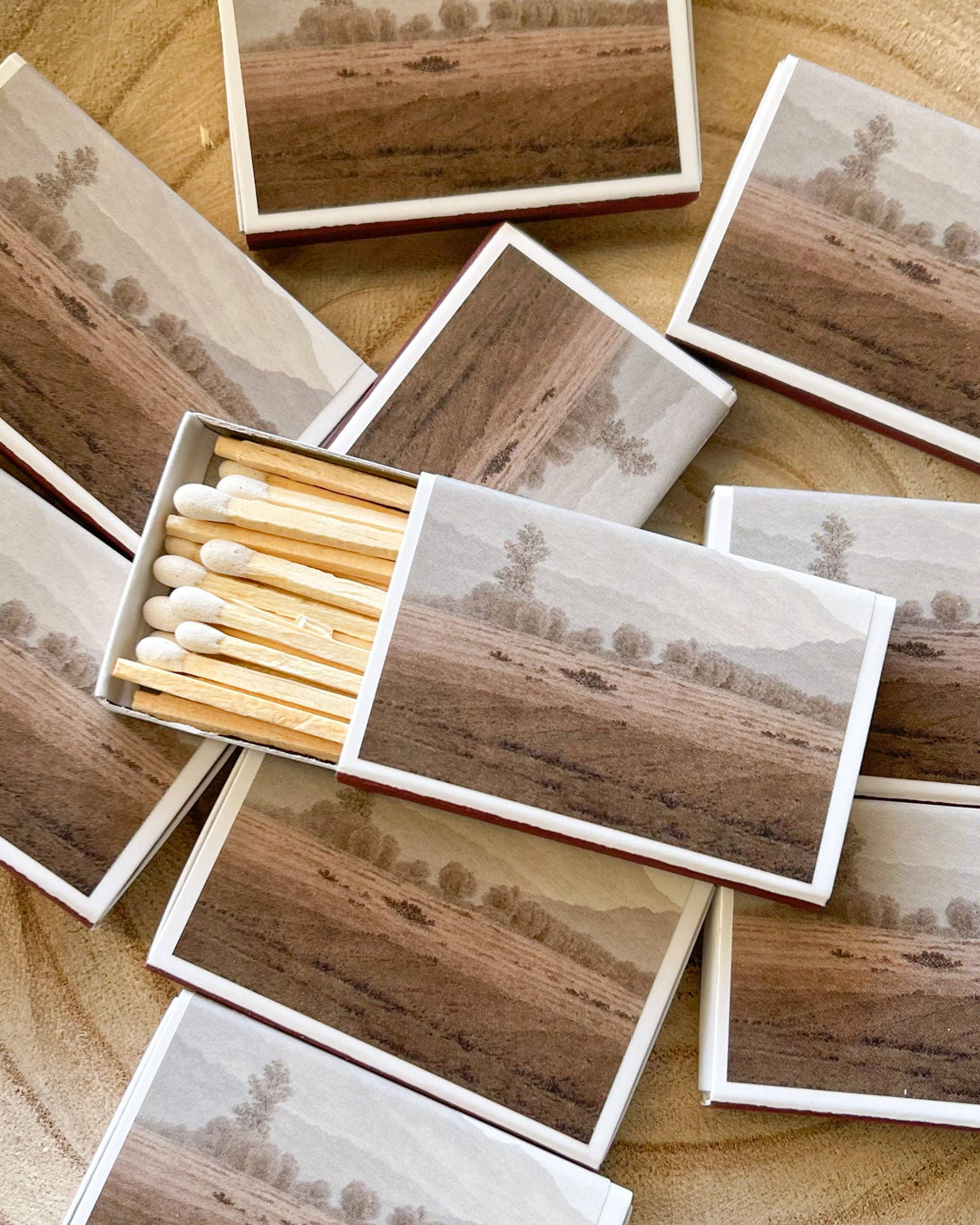 Matches with landscape designs on wooden surface