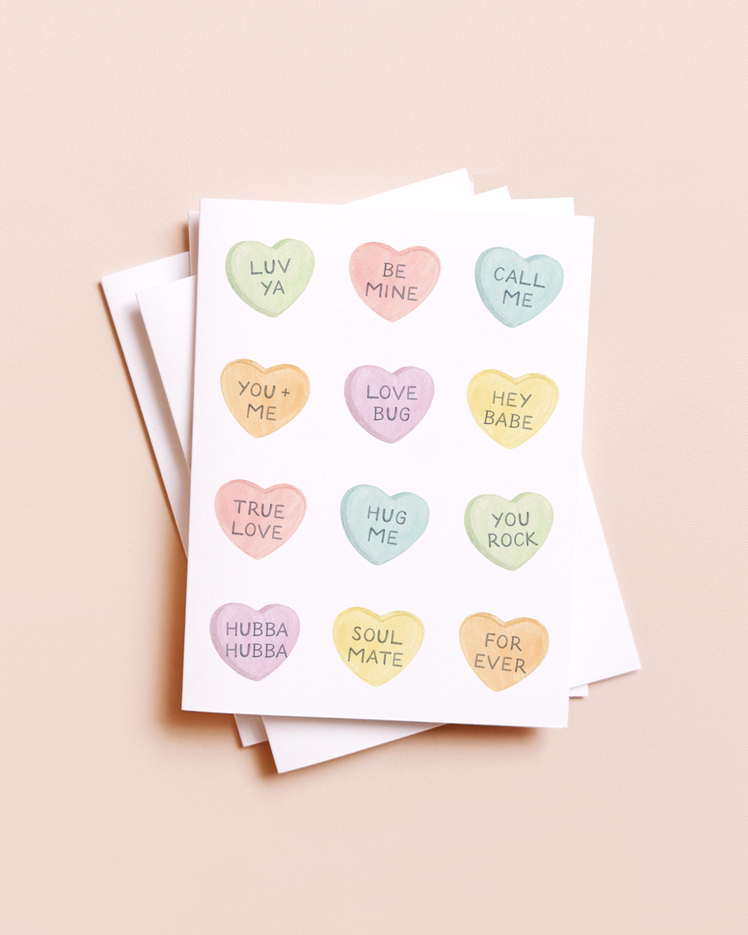 Set of greeting cards with colorful heart-shaped text on a beige background