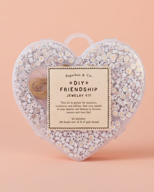 Heart-shaped DIY friendship jewelry kit with decorative elements on a white background