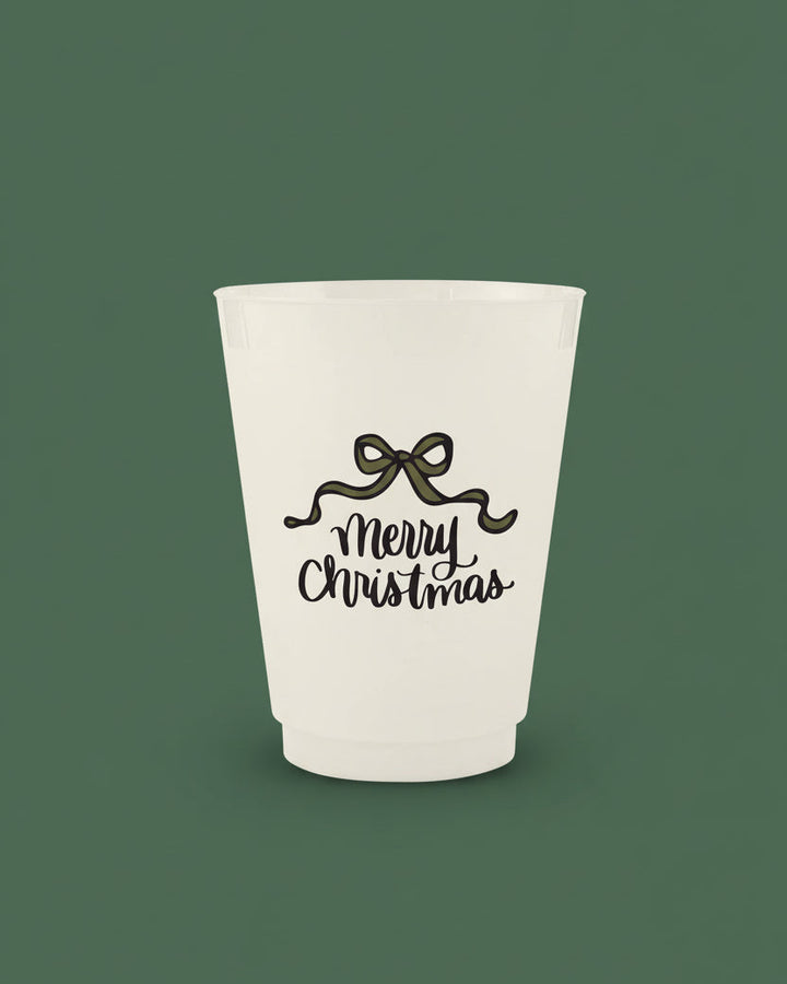 White ceramic tumbler with 'Merry Christmas' text and bow design on a white background