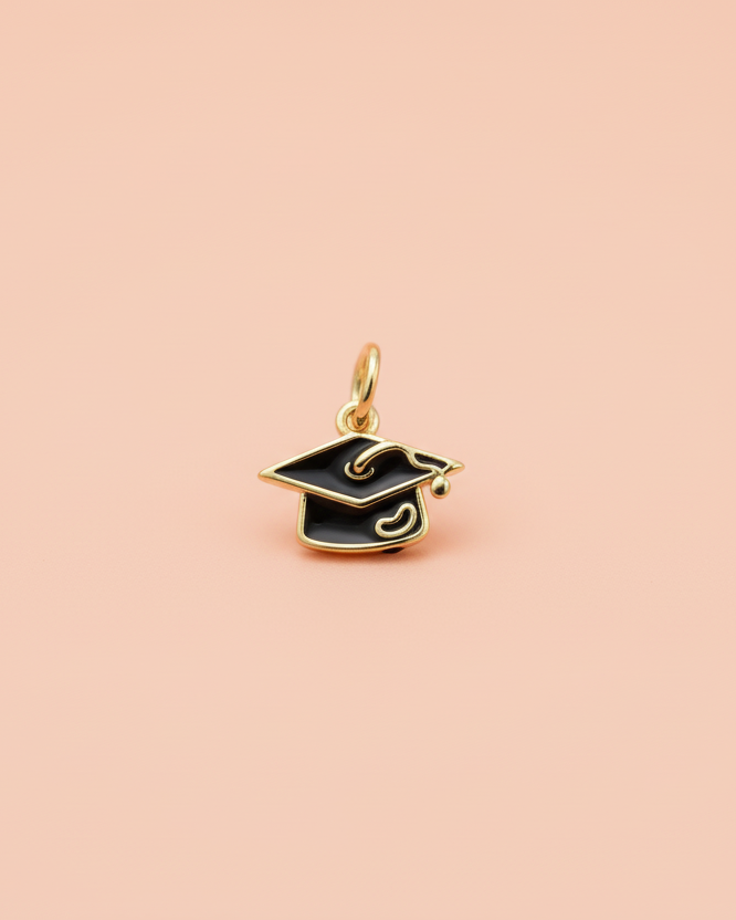 Gold graduation cap pendant on a white background