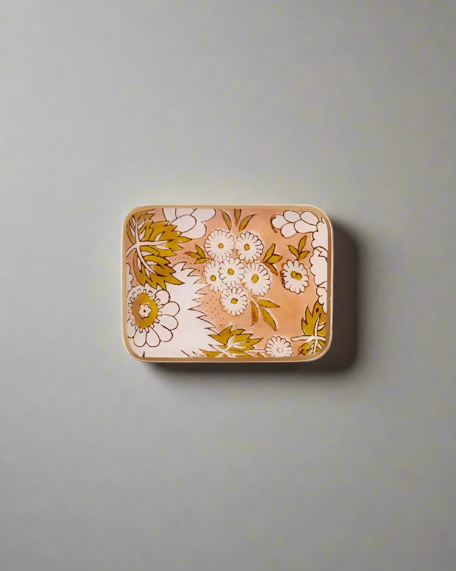 Rectangular tin with floral design on a white background