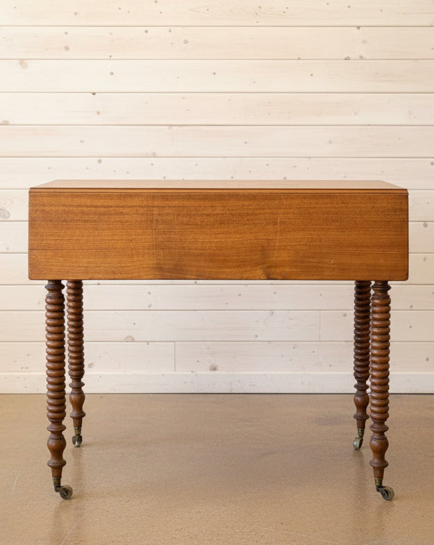 Wooden table with spiral legs in a room with wooden furniture