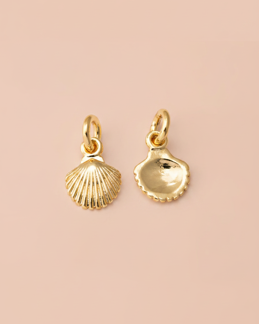 Gold shell-shaped pendants on a light gray background