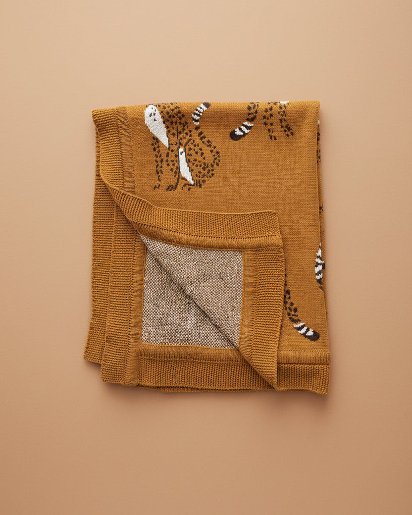 Brown knitted blanket with animal pattern on a white background