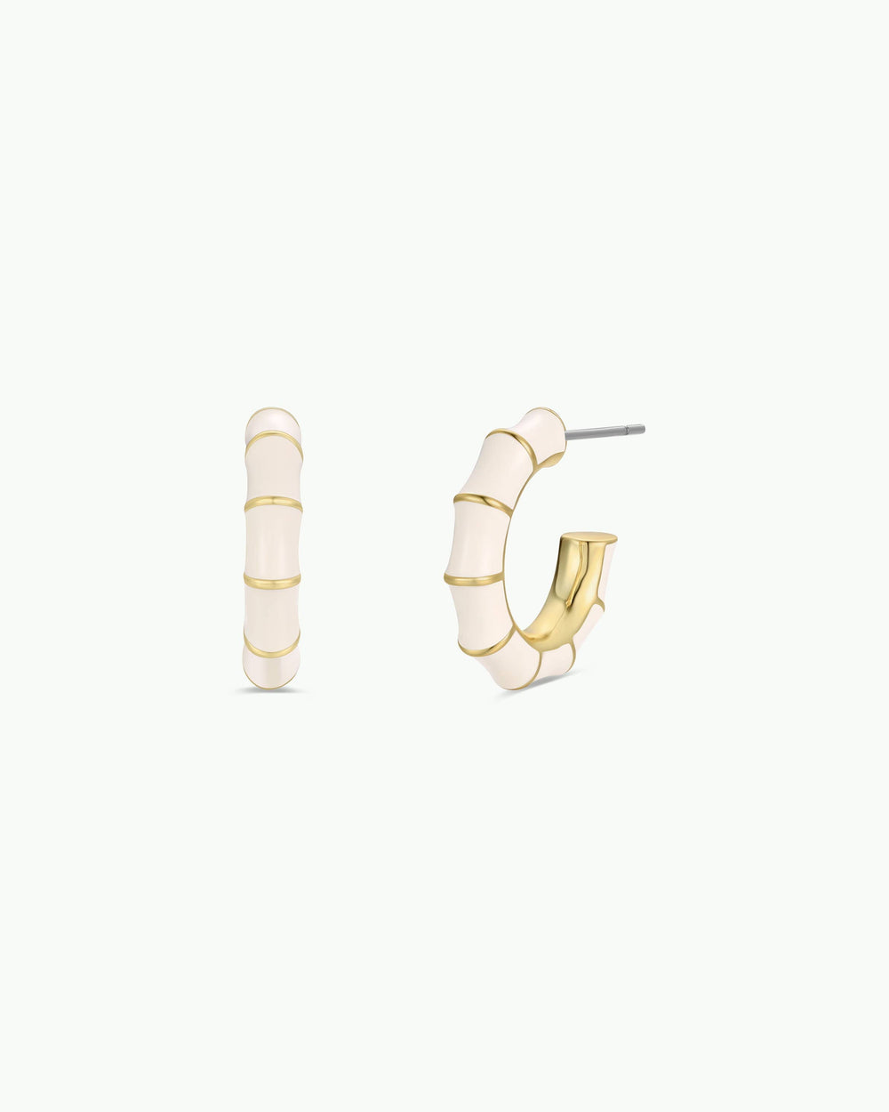 Gold and white hoop earrings on a white background