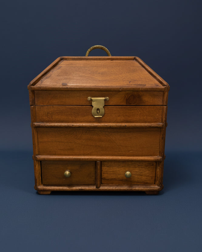 A wooden portable campaign chest with a brass padlock-ready latch and two slide-out drawers, mahogany stained and finished with beeswax.