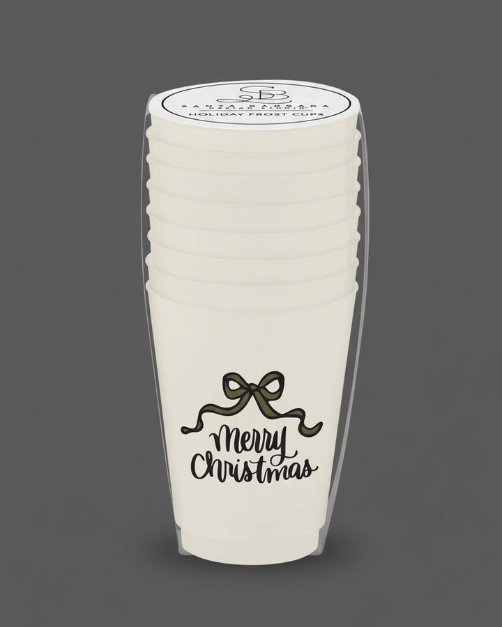 Stack of white paper cups with 'Merry Christmas' text and a bow design, branded 'Sara's Paperie'.
