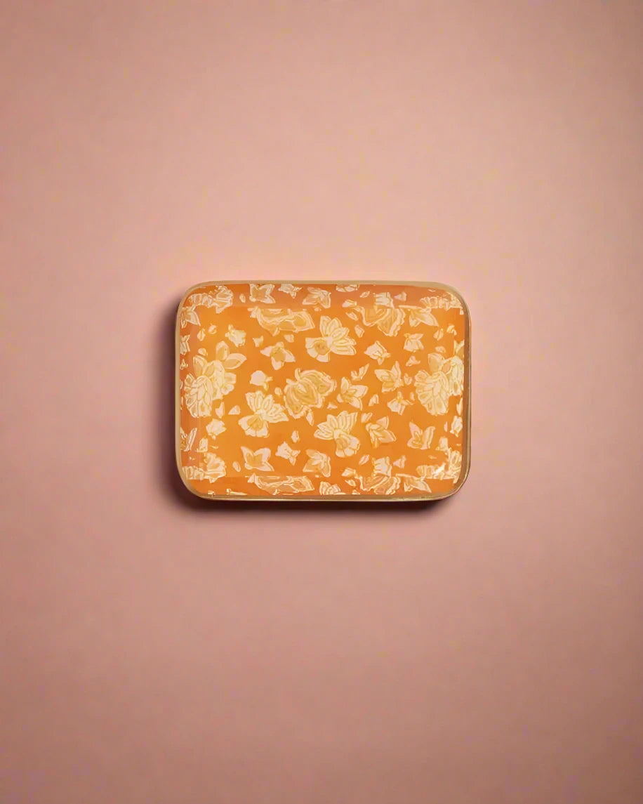 Small rectangular orange container with floral pattern on a white background